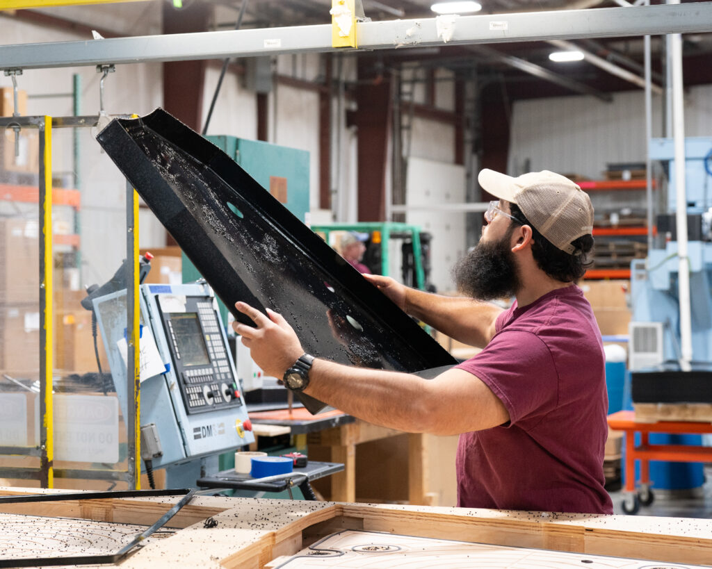 CNC Technician inspecting a part